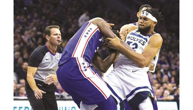 Joel Embiid (centre) of the Philadelphia 76ers fights with Karl-Anthony Towns (right) of the Minnesota Timberwolves in the NBA game in Philadelphia, United States, on Wednesday. (AFP)