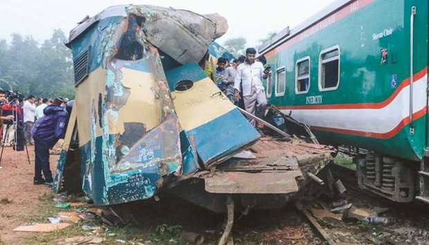 Bystanders look on after a train collided with another train in Brahmanbaria, some 130km from Dhaka, yesterday.