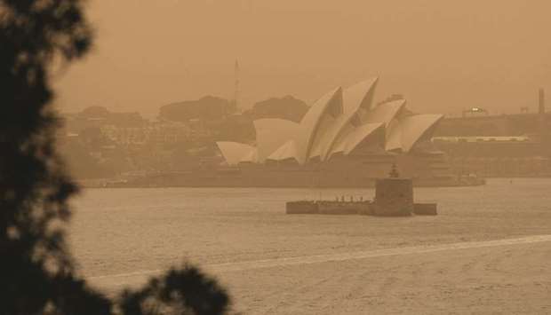 The Sydney Opera House is seen as smoke haze from bushfires drifts over the CDB in Sydney.