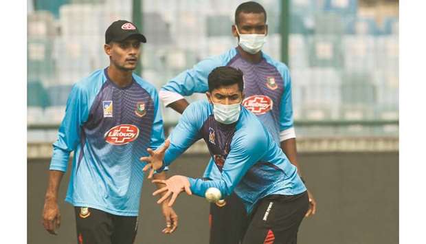Bangladeshu2019s Soumya Sarkar (foreground) wearing a face mask catches a ball during a practice session in New Delhi yesterday. (AFP)