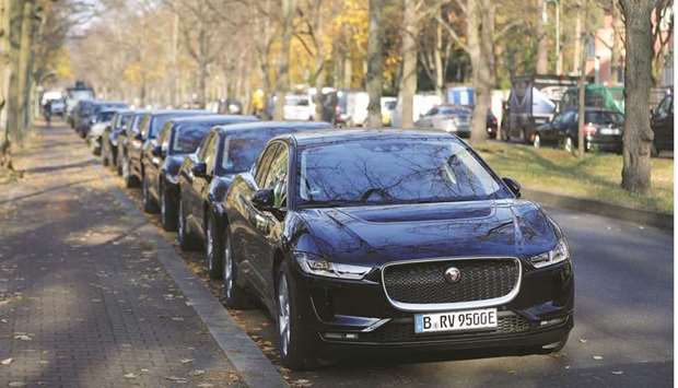 A line of Jaguar I-Pace electric automobiles sit parked as Jaguar Land Rover unveils a fleet of premium taxi service Jaguar I-Pace electric automobiles in Berlin (file). Tata Group, Indiau2019s largest conglomerate, has said itu2019s open to finding partners for JLR to save on costs and share the burden of investing in electric vehicles.