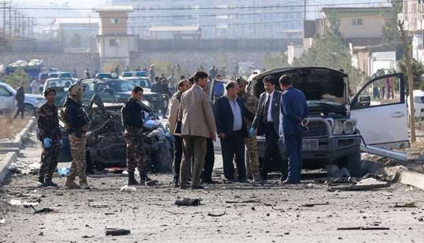 Security personnel and investigators gather at the site of a suicide attack in Kabul