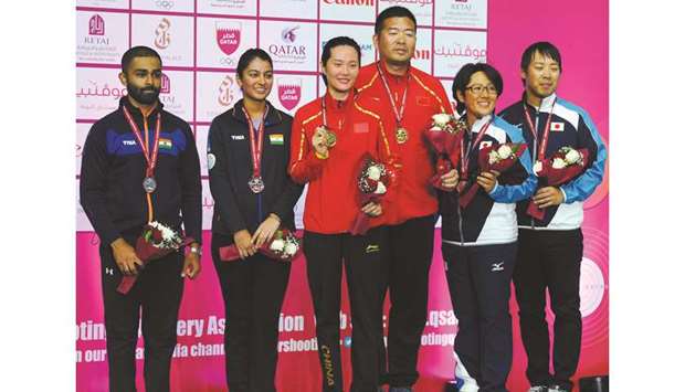 Mixed skeet team gold medallist Wei Meng and Jin Di (centre) of China, runner-up Indiau2019s Ganemat Sekhon and Angad Vir Singh Bajwa (left) and bronze medal winners Japanu2019s Naoko Ishihara and Hiroyuki Ikawa pose on the podium during the 14th Asian Shooting Championships at the Lusail Shooting Complex. PICTURES: Nasar T K