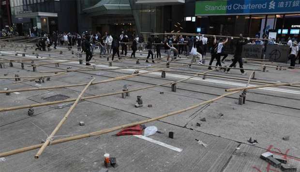 Protesters and office workers set up a barricade of bamboo and bricks during a protest in the Central district in Hong Kong