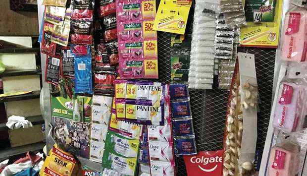 SPOTLIGHT: Plastic sachets of single use consumer goods hang from a storefront in Navotas, a suburb of Manila in the Philippines.