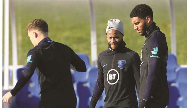 Englandu2019s Raheem Sterling (centre) and Joe Gomez (right) look on as Kieran Trippier trains yesterday ahead of their Euro 2020 qualifying match against Montenegro at St. Georgeu2019s Park, Burton upon Trent, Britain. (Reuters)