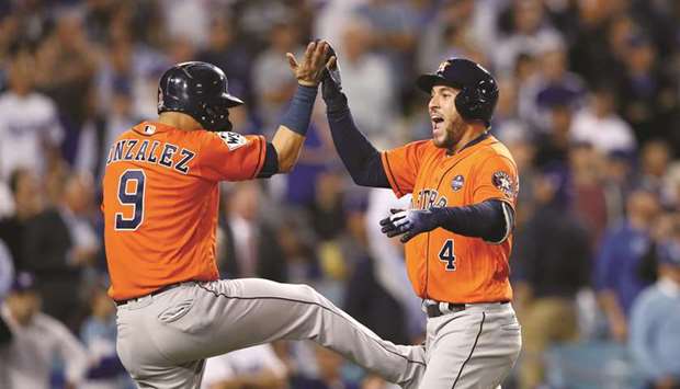 In this November 1, 2017, picture, George Springer (right) of the Houston Astros celebrates with Marwin Gonzalez after hitting a two-run home run during the second inning against the Los Angeles Dodgers in game seven of the 2017 World Series in Los Angeles, United States. (AFP)