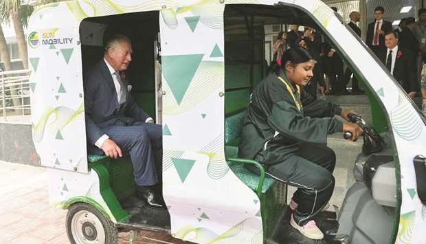 Britainu2019s Prince Charles takes a ride in an electric rickshaw during his visit to the Indian Meteorological Department in New Delhi yesterday.
