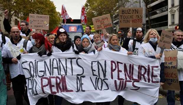 French hospitals and health workers on strike attend a demonstration urging the French government to provide more means, more staff to overworked hospitals and emergency services, in Paris, France