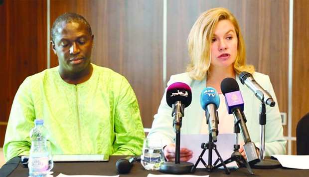 Steinerte speaks at a press conference as Adjovi looks on in Doha