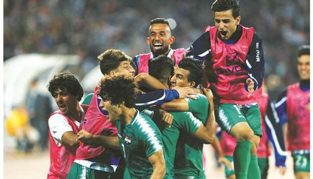 Iraq players celebrate after scoring against Iran in the World Cup 2022 qualifier at the Amman International Stadium in Amman, Jordan, yesterday. (Reuters)
