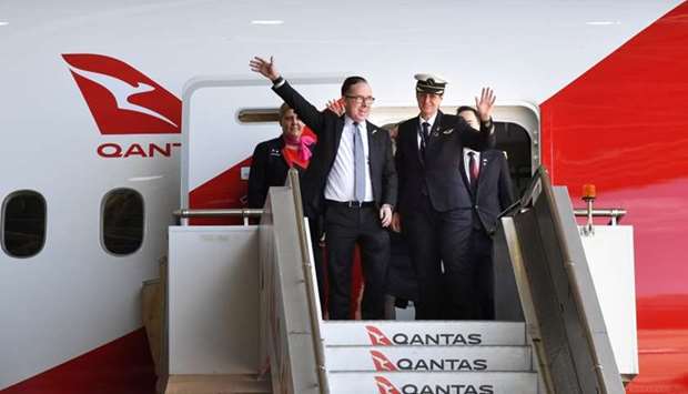 Qantas CEO Alan Joyce and crew members of flight QF7879, which flew direct from London to Sydney, disembark the plane during the Qantas Centenary Launch at Qantas Sydney Jet Base in Sydney, Australia,