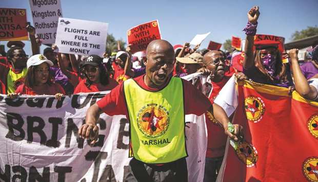 A SAA (South African Airways) worker and union member are seen during a picket protest outside the OR Tambo International Airport in Johannesburg, yesterday.