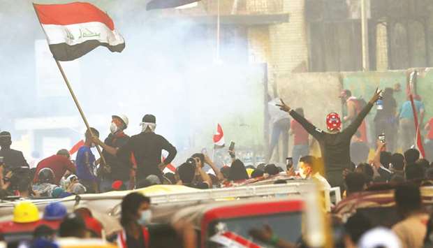 Iraqi demonstrators take part in ongoing anti-government protests in Baghdad, yesterday.