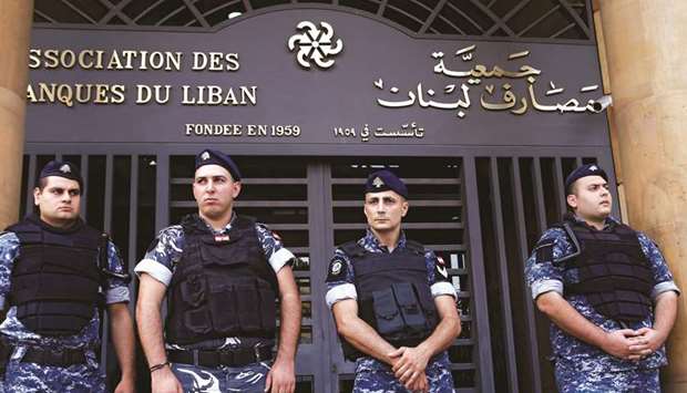 Lebanese police stand outside the entrance to the Association of Banks in downtown Beirut on November 1. S&P Global Ratings downgraded Lebanonu2019s long-term foreign currency debt rating to CCC from B- after the market closed on Friday, following the rating companyu2019s decision to downgrade three of the nationu2019s top banks the previous day.