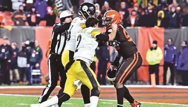 Cleveland Browns defensive end Myles Garrett (right) hits Pittsburgh Steelers quarterback Mason Rudolph with his own helmet as offensive guard David DeCastro tries to stop Garrett during the fourth quarter at FirstEnergy Stadium. PICTURE: USA TODAY Sports