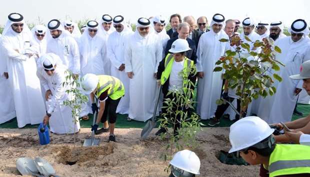 Dignitaries with schoolchildren during the tree-planting exercise. PICTURE: Thajudheen