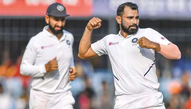 Mohammed Shami (right) celebrates after the dismissal of Bangladeshu2019s Taijul Islam during the third day of the first Test match at Holkar Cricket Stadium in Indore yesterday. (AFP)