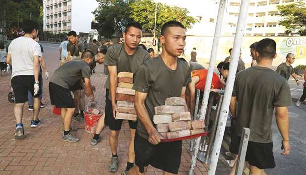 Personnel from the Chinese Peopleu2019s Liberation Army (PLA) barracks in Hong Kong emerged on to the city streets yesterday, to help the clean-up after a week of violence and disruption caused by pro-democracy protesters.