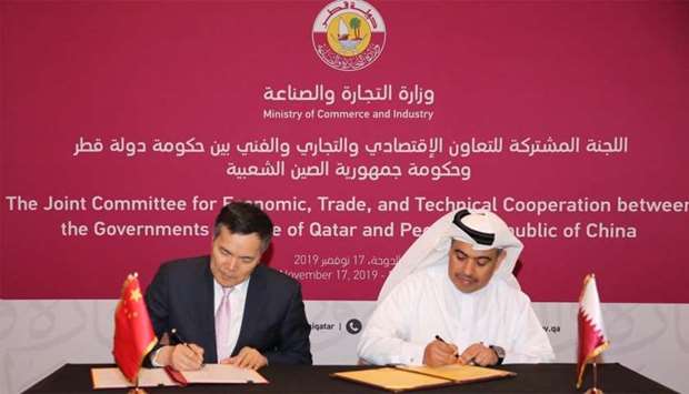 Al-Kuwari and Keming signing the minutes of the meeting.rnrn