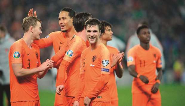 Netherlandsu2019 defender Joel Veltman (C) and teammates celebrate their qualification  on Saturday.