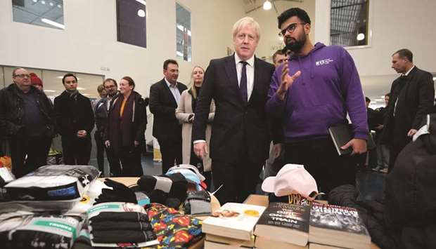 Prime Minister Boris Johnson speaks to staff and students as he visits the University of Bolton, after a large fire broke out at a student accommodation on Friday night, in Bolton, Britain.