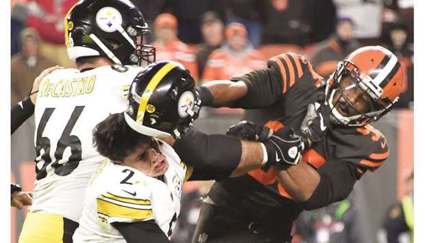 Cleveland Browns defensive end Myles Garrett hits Pittsburgh Steelers quarterback Mason Rudolph over the head with his helmet during the second half at FirstEnergy Stadium in Cleveland, Ohio, on Thursday. (Getty Images/TNS)