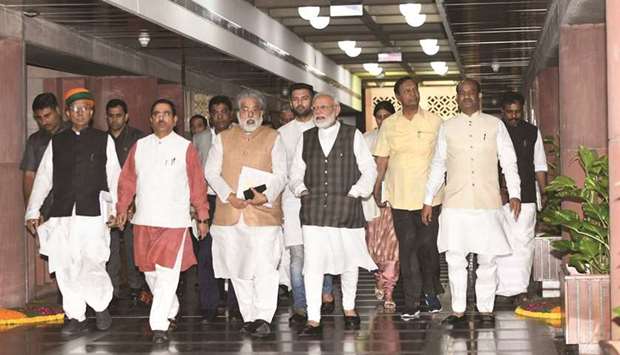 Prime Minister Narendra Modi accompanied by Lok Sabha Speaker Om Birla, ministers and leaders of parties arrives for an all-party meeting on the eve of the winter session of parliament, in New Delhi yesterday.