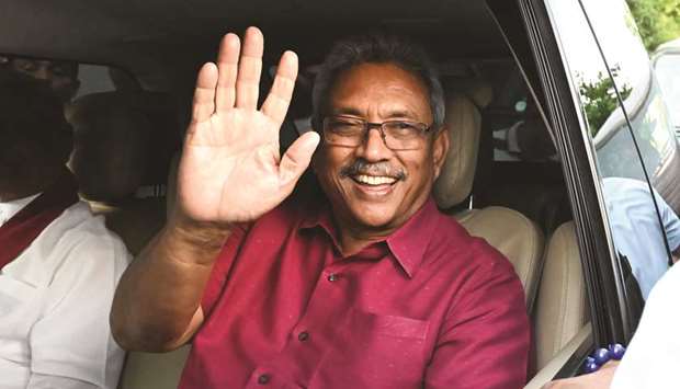 Sri Lankau2019s president-elect Gotabaya Rajapaksa waves at supporters as he leaves the election commission office in Colombo yesterday.