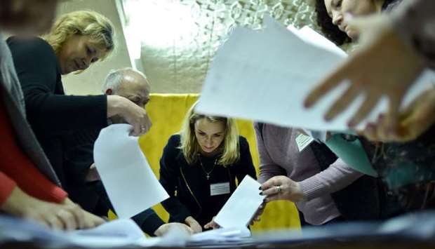 Members of a local electoral commission count votes at a polling station after the Belarus' parliamentary election in the village of Kreva, some 10 km northwest of Minsk yesterday.
