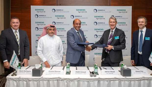 Siemens and Mannai officials after signing the agreement.rnrn