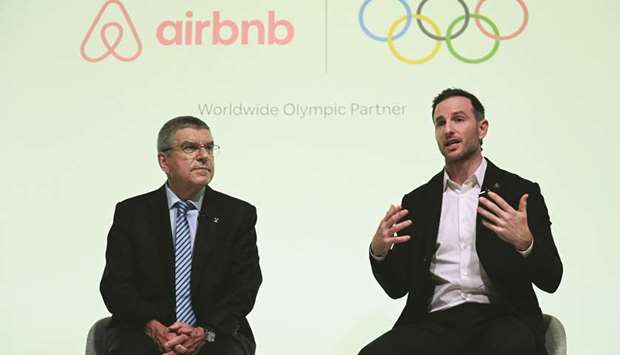 International Olympic Committee (IOC) President Thomas Bach (L) and Airbnb  co-founder Joe Gebbia speak at an event in London to announce Airbnb as a leading partner of the Olympics.