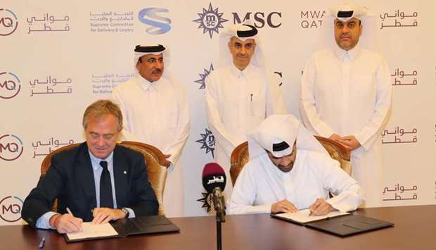 Hassan al-Thawadi and Pierfrancesco Vago signing the agreement as HE Jassim Seif Ahmed al-Sulaiti and other officials look on. PICTURE: Othman Iraqi