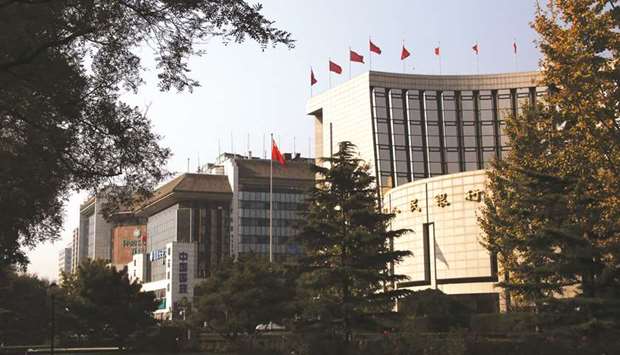 The Peopleu2019s Bank of China headquarters (right) in Beijing. The PBoC cut the interest rate on its seven-day reverse repurchase agreements to 2.5% from 2.55% yesterday.