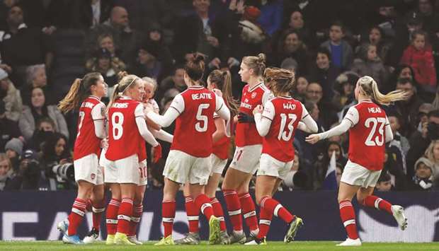 Arsenal players celebrate after scoring a goal during their win over Tottenham Hotspur in the Womenu2019s Super League in London. (Reuters)