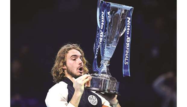Greeceu2019s Stefanos Tsitsipas poses with the winneru2019s trophy after winning the ATP World Tour Finals title at the O2 Arena in London on Sunday.