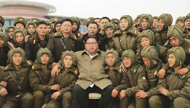 North Korean leader Kim Jong-un posing with members of the Air and Anti-Aircraft Force of the Korean Peopleu2019s Army during an airborne insertion training at an undisclosed location.