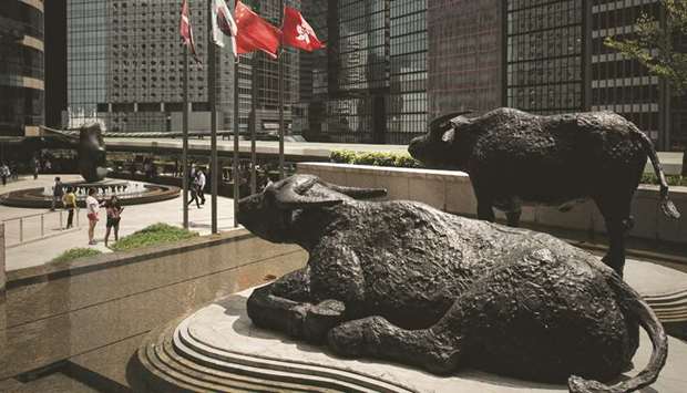 Bull statues displayed outside the Hong Kong Stock Exchange. The Hang Seng index closed up 1.4% to 26,681.09 points yesterday.