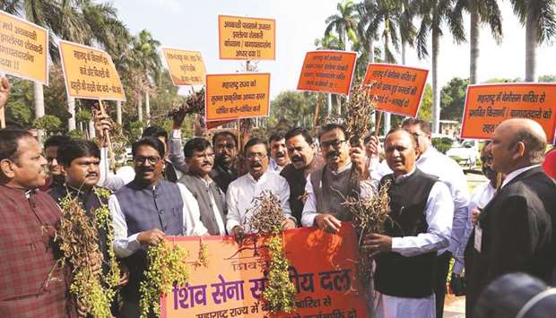Shiv Sena MPs stage a demonstration seeking immediate relief for farmers affected by unseasonal rains in parts of Maharashtra outside parliament in New Delhi yesterday.