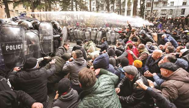Riot police use a water cannon to disperse demonstrators during a protest against the government in Tbilisi.