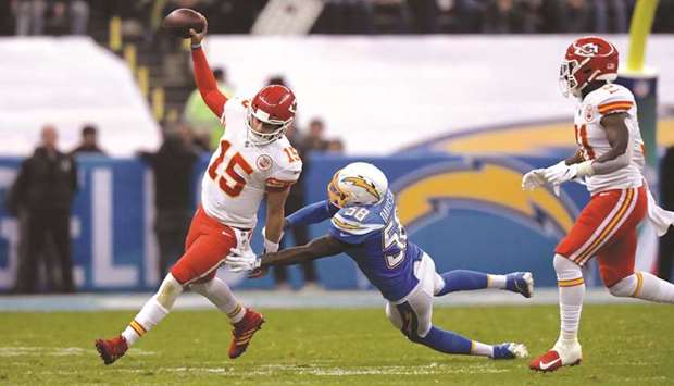 Kansas City Chiefs quarterback Patrick Mahomes (15) is pursued by Los Angeles Chargers outside linebacker Thomas Davis (58) in the third quarter of their NFL International Series game at Estadio Azteca. The Chiefs defeated the Chargers 24-17. PICTURE: Kirby Leeu2013USA TODAY Sports