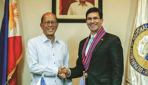 US Defence Secretary Mark Esper shakes hands with his Philippine counterpart Delfin Lorenzana during a news conference at the military headquarters, Camp Aguinaldo in Quezon City, Metro Manila, yesterday.