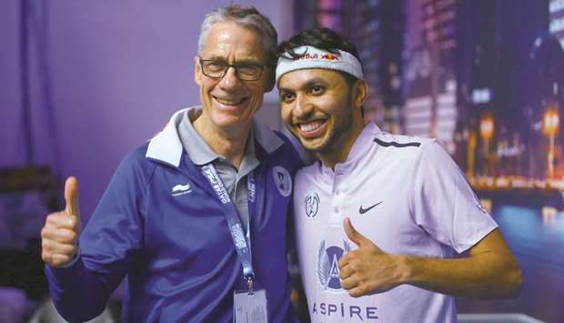 Qataru2019s Abdulla al-Tamimi (right, also left) and coach Geoff Hunt celebrate his first round PSA Menu2019s World Squash Championships win over Gregoire March in Doha earlier this month. PICTURES: Jayan Orma
