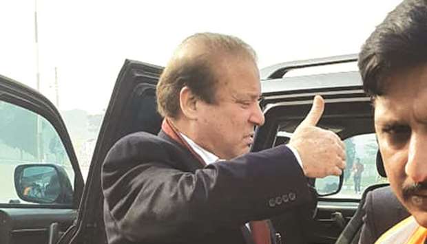 Sharif giving a thumbs-up to supporters before boarding the air ambulance.