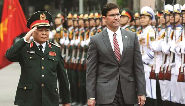 US Defence Secretary Mark Esper reviews the guard of honour with Vietnamu2019s Defence Minister General Ngo Xuan Lich in Hanoi yesterday.