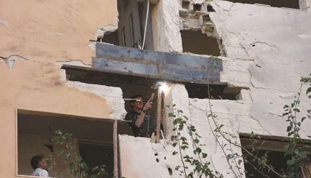 A worker fixes the damage to a building from an Israeli attack in #Damascus, #Syria yesterday.