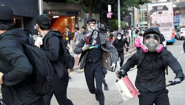 Protesters run during a march billed as a global ,emergency call, for autonomy, in Hong Kong