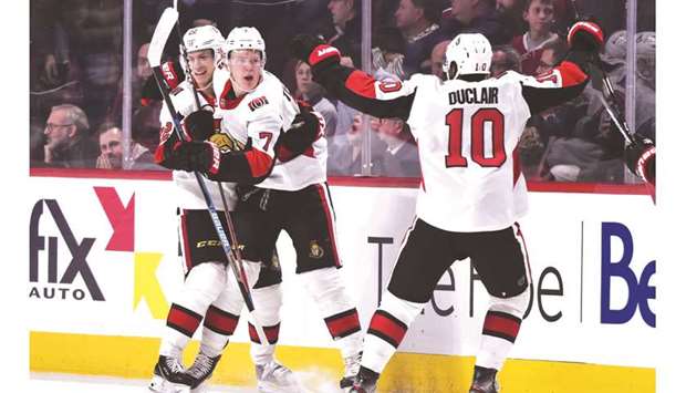 Brady Tkachuk (centre) of the Ottawa Senators celebrates his overtime goal with teammate Nikita Zaitsev (left) and Anthony Duclair against the Montreal Canadiens at the Bell Centre in Montreal.
