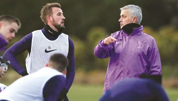 Tottenhamu2019s new manager Jose Mourinho (right) talks to striker Harry Kane during a training session yesterday.