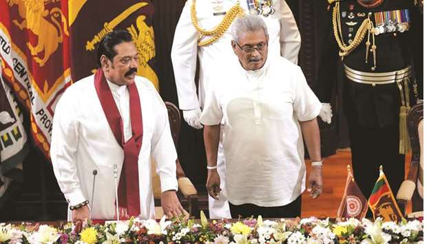 Sri Lankau2019s President Gotabaya Rajapaksa and his brother and former leader Mahinda Rajapaksa, who was appointed as the new Prime Minister, look on during the swearing in ceremony in Colombo.